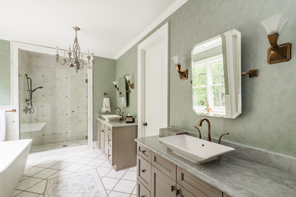 Design ideas for an expansive transitional master bathroom in Atlanta with shaker cabinets, white cabinets, a freestanding tub, an alcove shower, a one-piece toilet, ceramic tile, green walls, a vessel sink, marble benchtops, white floor and a hinged shower door.