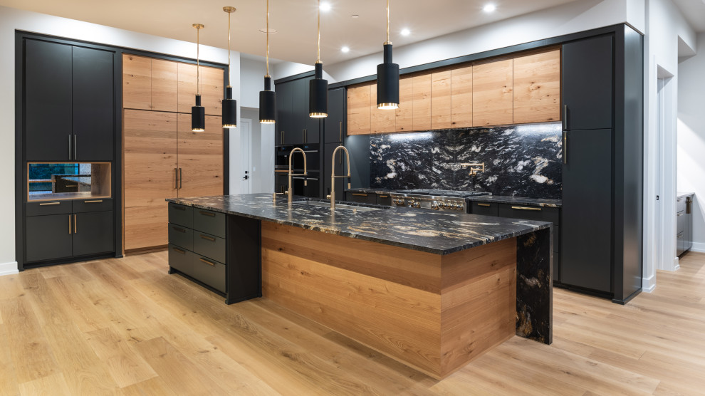 Design ideas for a mid-sized contemporary l-shaped kitchen pantry in Austin with flat-panel cabinets, white cabinets, granite benchtops, multi-coloured splashback, stone tile splashback and black benchtop.
