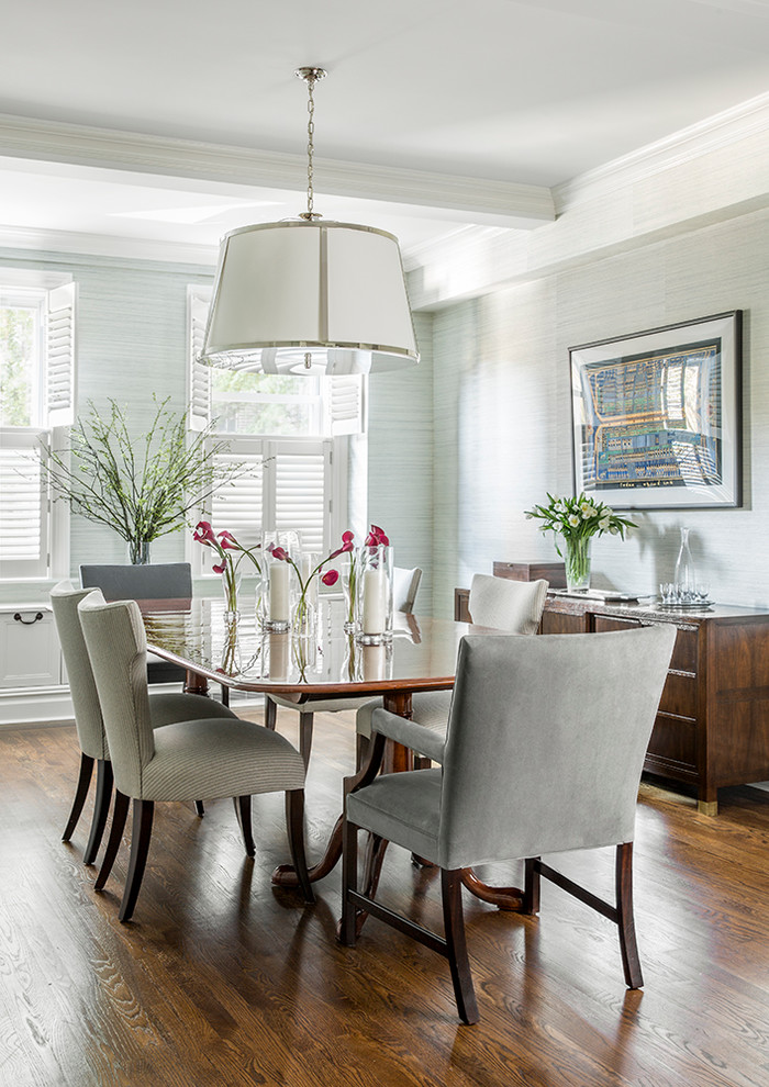 This is an example of a large traditional dining room in New York with medium hardwood floors and grey walls.