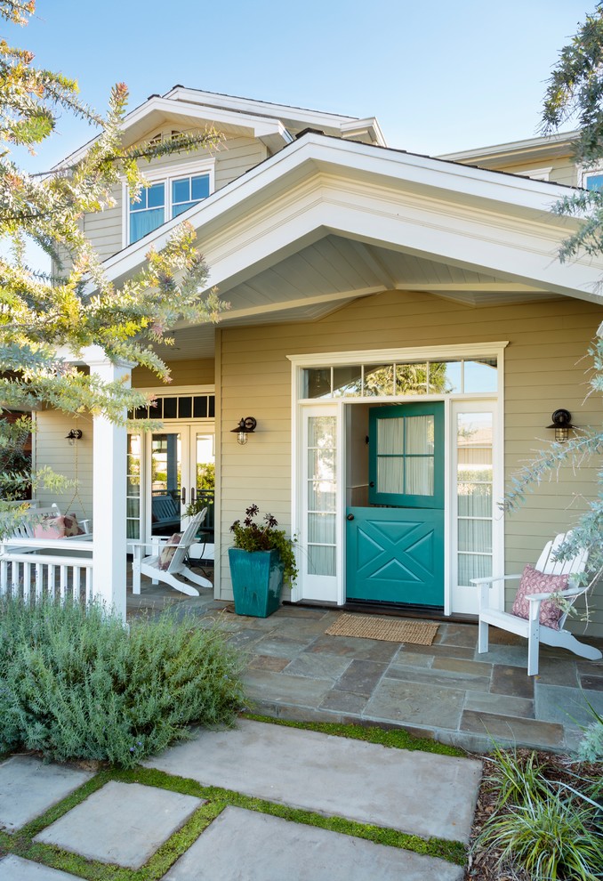 This is an example of a beach style entryway in Los Angeles with a dutch front door and a blue front door.