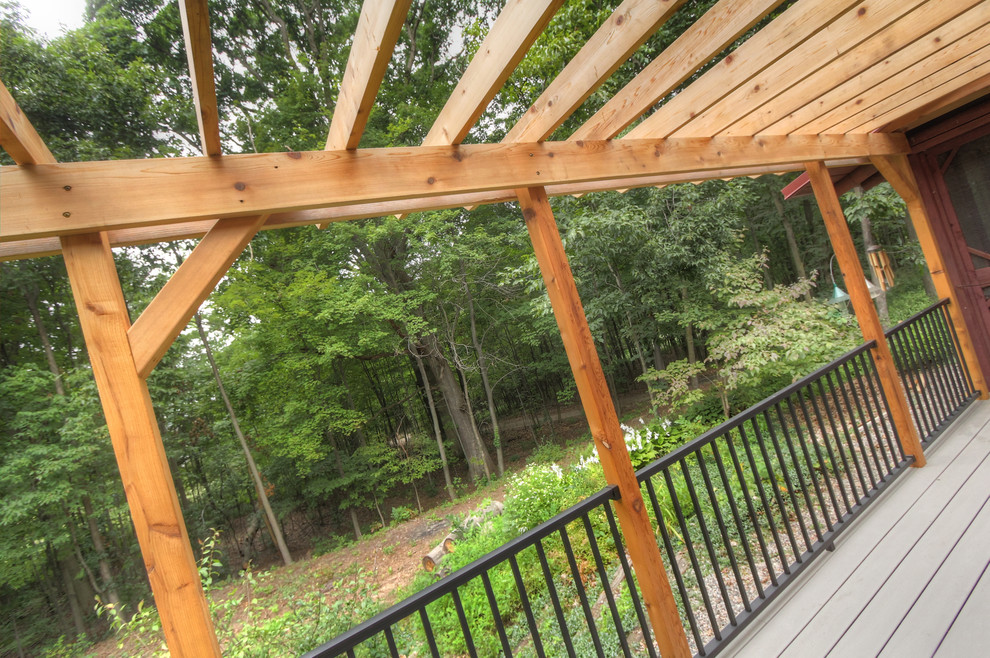 Photo of a small country backyard deck in Grand Rapids with a pergola.