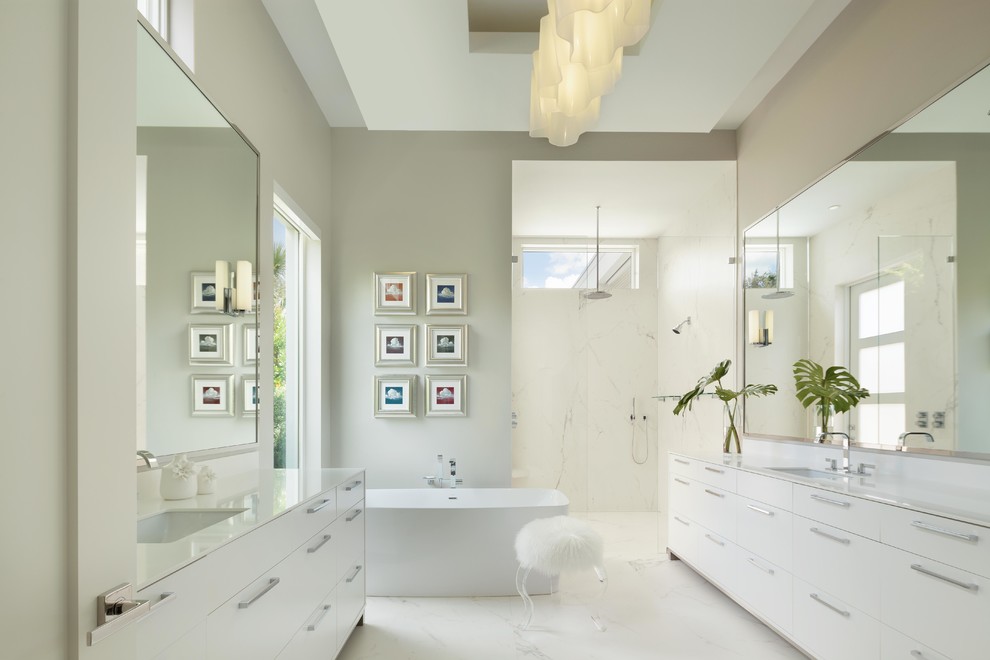 Contemporary master bathroom in Miami with flat-panel cabinets, white cabinets, a freestanding tub, an alcove shower, grey walls, an undermount sink and a hinged shower door.