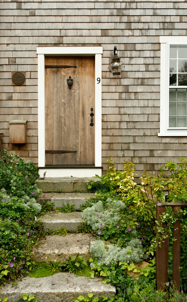 Inspiration for a beach style entryway in Boston with a single front door and a medium wood front door.