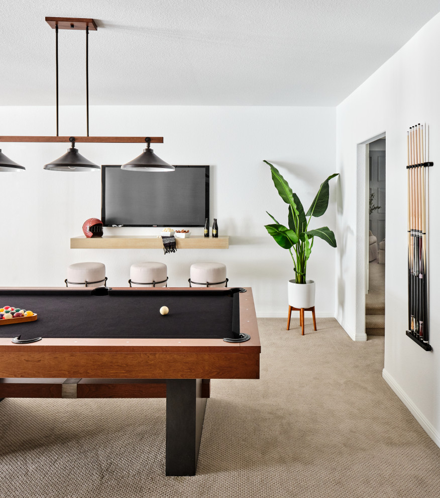 Belterra Project- Furnishings, Lighting Fixtures & Interior Design - This sophisticated game room provides hours of play for a young and active family.  The black, white and beige color scheme adds a masculine touch.  Wood and iron accents are repeated throughout the room in the armchairs, pool table, pool table light fixture and in the custom built in bar counter.  This pool table also accommodates a ping pong table top, as well, which is a great option when space doesn't permit a separate pool table and ping pong table.  Since this game room loft area overlooks the home's foyer and formal living room, the modern color scheme unites the spaces and provides continuity of design.  A custom white oak bar counter and iron barstools finish the space and create a comfortable hangout spot for watching a friendly game of pool.