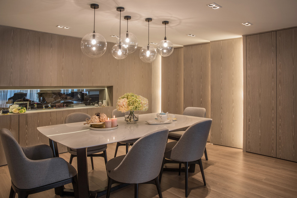 This is an example of a contemporary dining room in Hong Kong with medium hardwood floors.