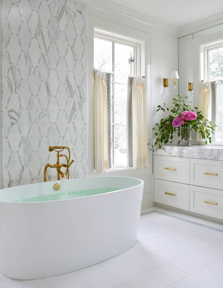 Design ideas for a large transitional master bathroom in Dallas with shaker cabinets, white cabinets, a freestanding tub, a two-piece toilet, multi-coloured tile, stone slab, white walls, porcelain floors, an undermount sink, quartzite benchtops and white floor.