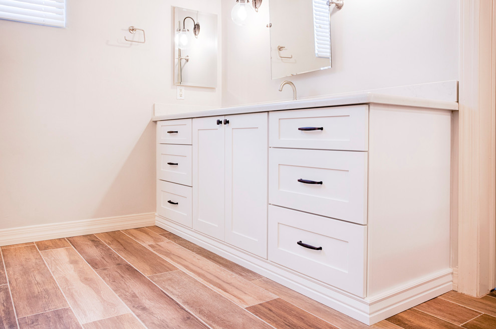 Example of a huge transitional master brown tile and porcelain tile porcelain tile freestanding bathtub design in Phoenix with shaker cabinets, white cabinets, a two-piece toilet, gray walls, an undermount sink and quartzite countertops
