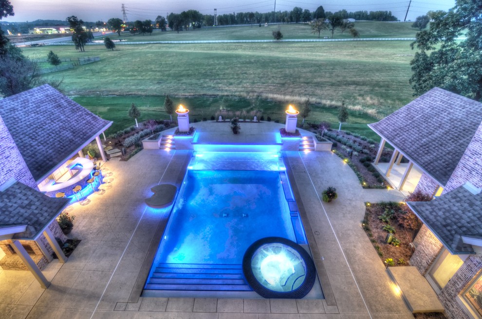 Example of a large transitional backyard concrete paver and rectangular natural hot tub design in Cedar Rapids