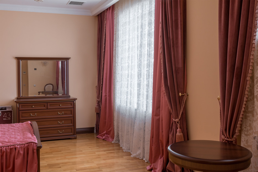 Photo of a large classic master bedroom in Moscow with pink walls, medium hardwood flooring, beige floors and a drop ceiling.