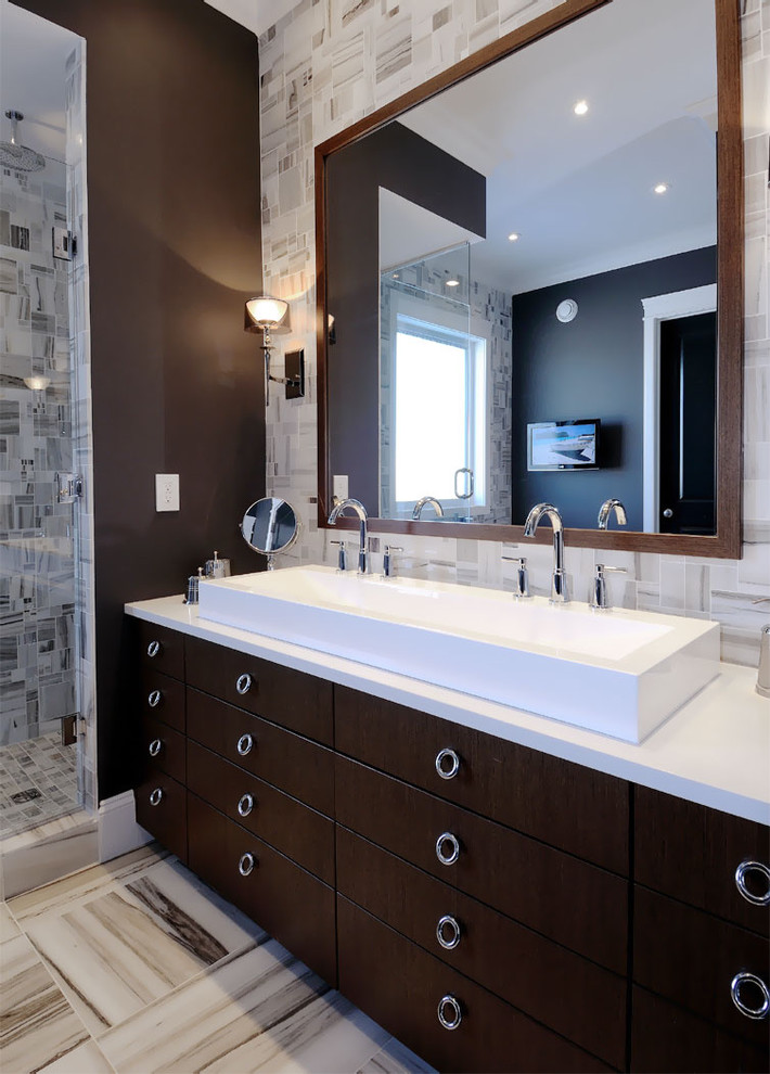 Contemporary bathroom in Other with a trough sink, flat-panel cabinets, dark wood cabinets and gray tile.