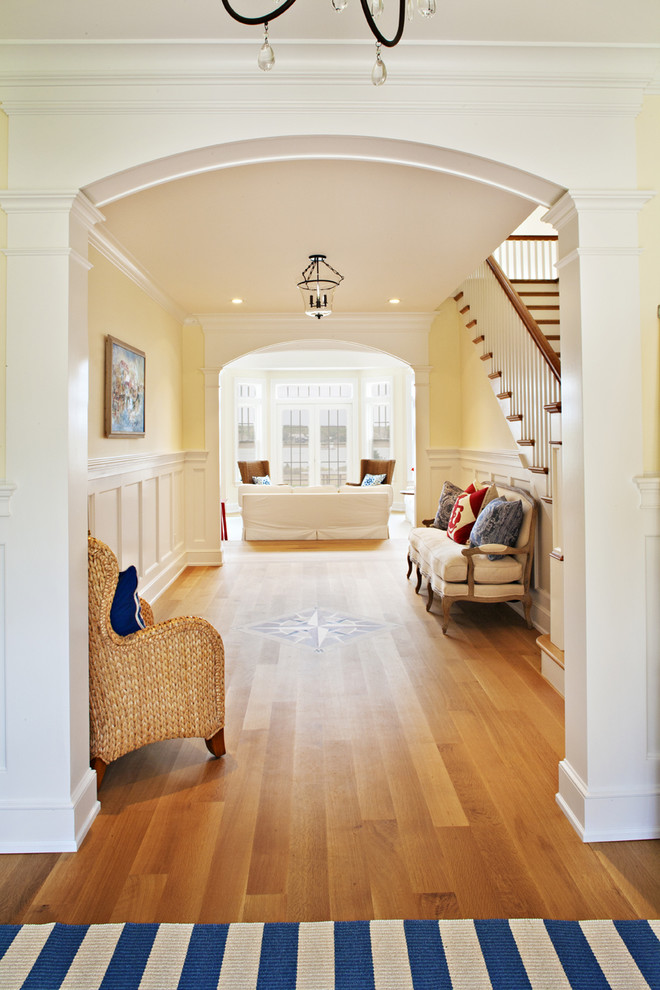 Design ideas for a beach style hallway in Boston with yellow walls.