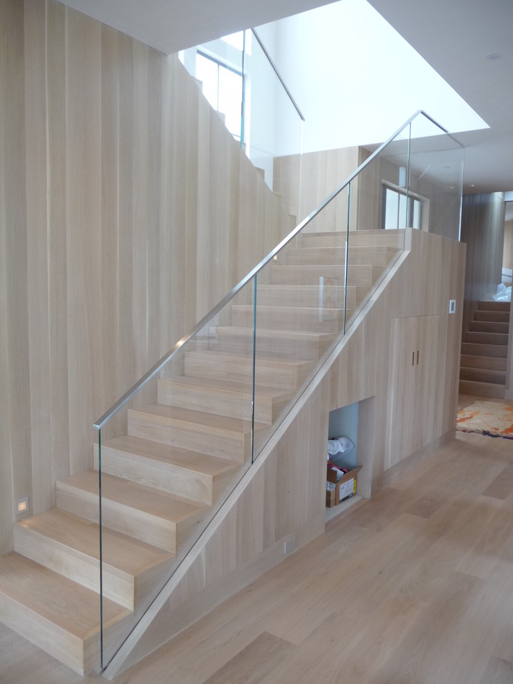 Inspiration for a contemporary wood u-shaped staircase in Los Angeles with wood risers.