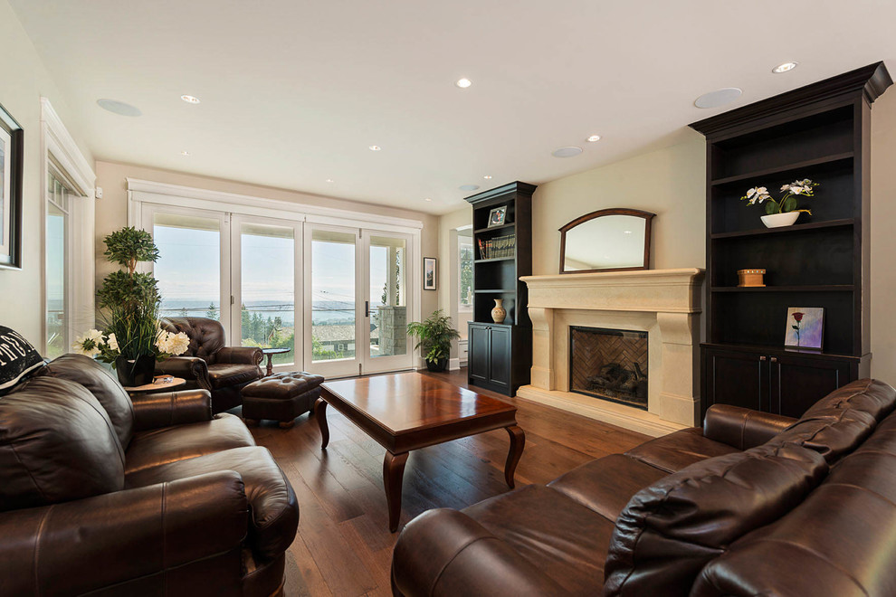 Photo of a large traditional formal open concept living room in Vancouver with beige walls, dark hardwood floors, a standard fireplace, a stone fireplace surround, no tv and beige floor.