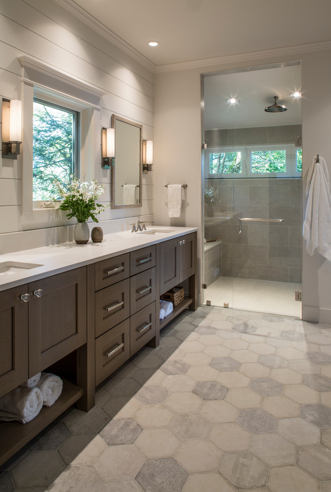 Photo of a mid-sized transitional master bathroom in Other with medium wood cabinets, a double shower, a two-piece toilet, gray tile, ceramic tile, white walls, ceramic floors, an undermount sink, engineered quartz benchtops, grey floor, a hinged shower door, white benchtops and shaker cabinets.
