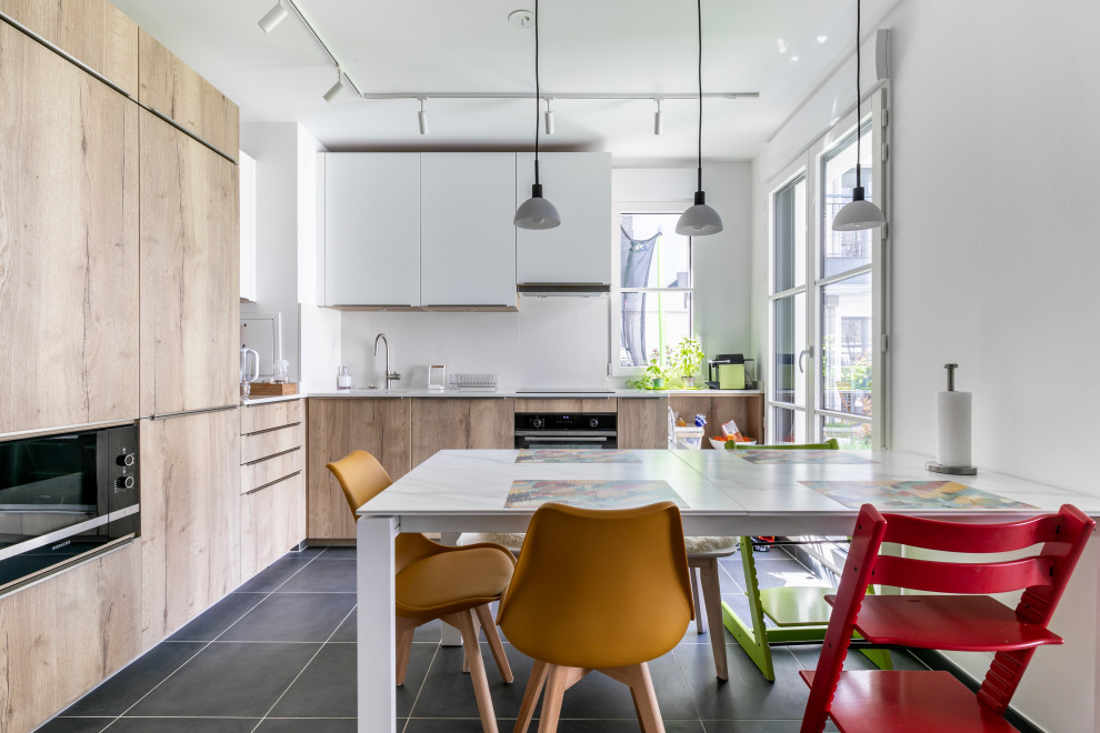 Design ideas for a mid-sized contemporary l-shaped eat-in kitchen in Paris with light wood cabinets, ceramic floors and grey floor.