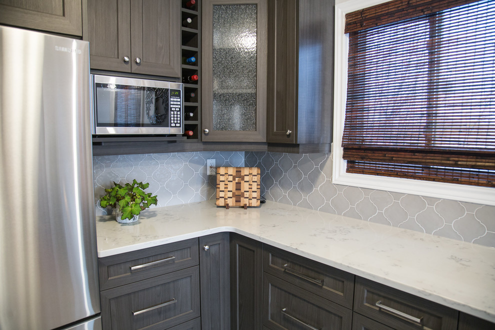 Example of a mid-sized transitional galley porcelain tile and beige floor enclosed kitchen design in Toronto with an undermount sink, recessed-panel cabinets, dark wood cabinets, quartzite countertops, gray backsplash, ceramic backsplash, stainless steel appliances, no island and white countertops