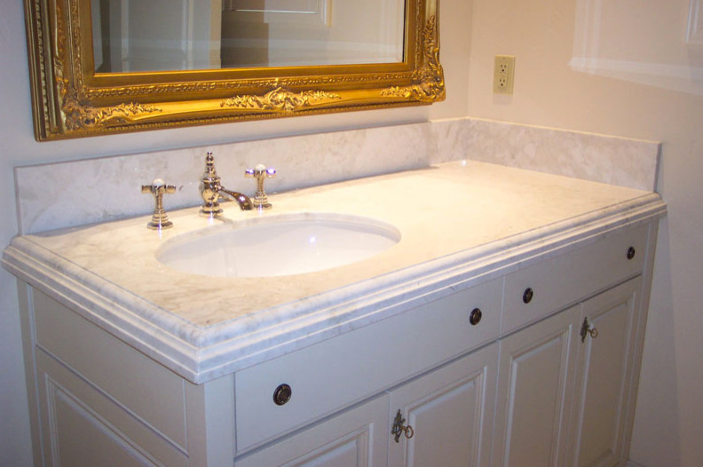 Mid-sized white tile bathroom photo with recessed-panel cabinets, medium tone wood cabinets and granite countertops