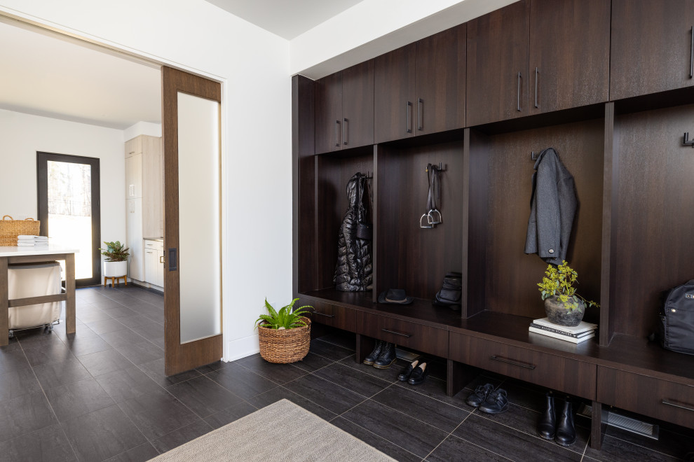 Large contemporary entrance in Other with white walls, porcelain flooring, a sliding front door and black floors.