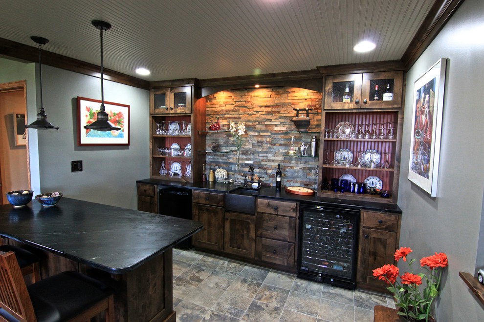 Design ideas for a mid-sized transitional seated home bar in Minneapolis with an undermount sink, shaker cabinets, dark wood cabinets, multi-coloured splashback, slate splashback, slate floors and brown floor.