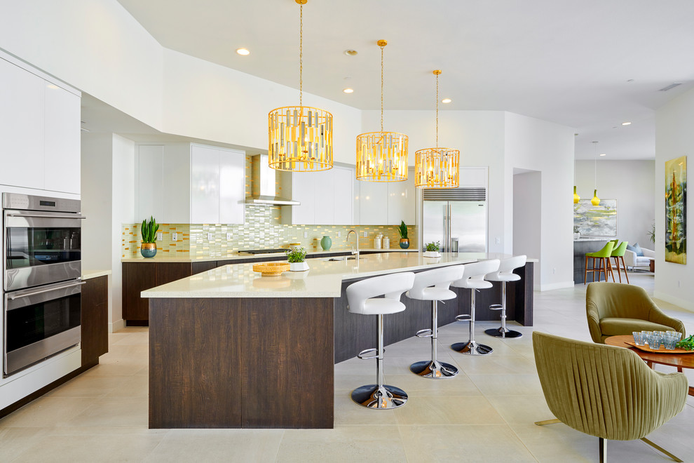 Design ideas for a midcentury open plan kitchen in Orange County with a double-bowl sink, flat-panel cabinets, white cabinets, metallic splashback, metal splashback, stainless steel appliances, with island, beige floor and beige benchtop.