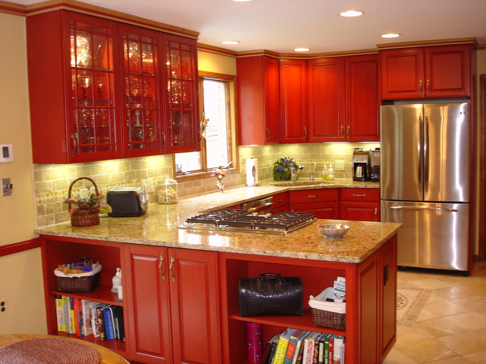 Design ideas for a transitional u-shaped eat-in kitchen in Baltimore with an undermount sink, raised-panel cabinets, red cabinets, granite benchtops, beige splashback, stone tile splashback, stainless steel appliances and porcelain floors.