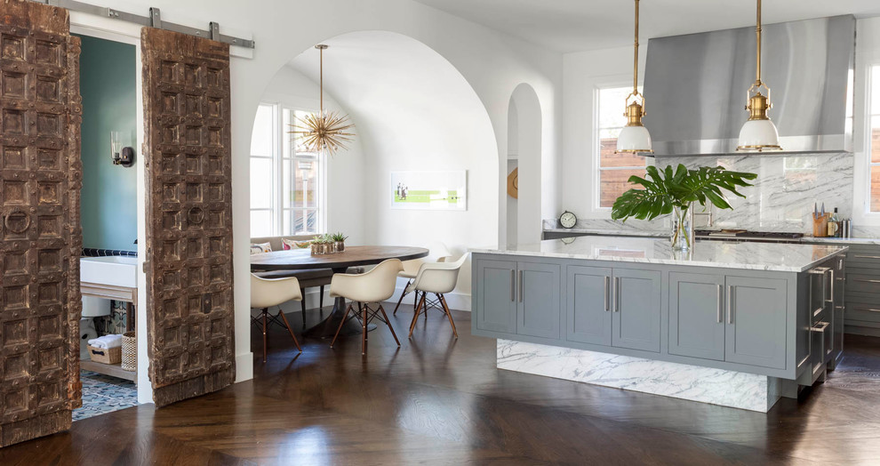 Open concept kitchen - contemporary galley dark wood floor open concept kitchen idea in Dallas with a drop-in sink, shaker cabinets, gray cabinets, marble countertops, white backsplash, stone slab backsplash, stainless steel appliances and an island