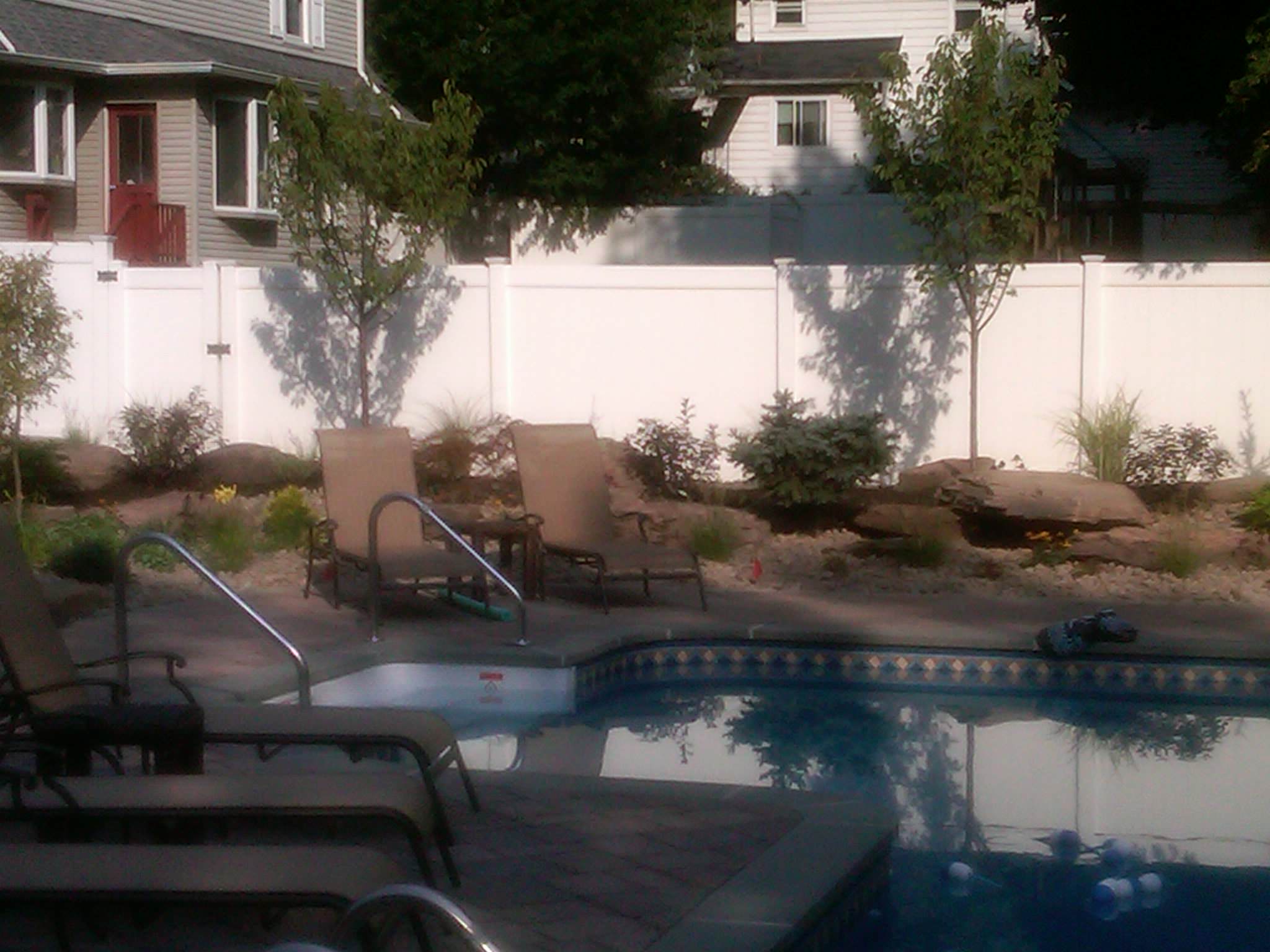 backyard landscape 'firepit''waterfall'tiered patio's pool with bluestone coping