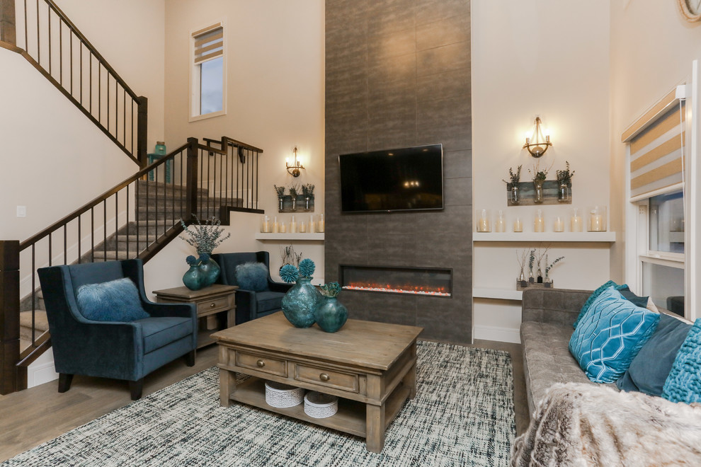 This is an example of a mid-sized transitional enclosed living room in Edmonton with grey walls, medium hardwood floors, a ribbon fireplace, a tile fireplace surround, a wall-mounted tv and brown floor.