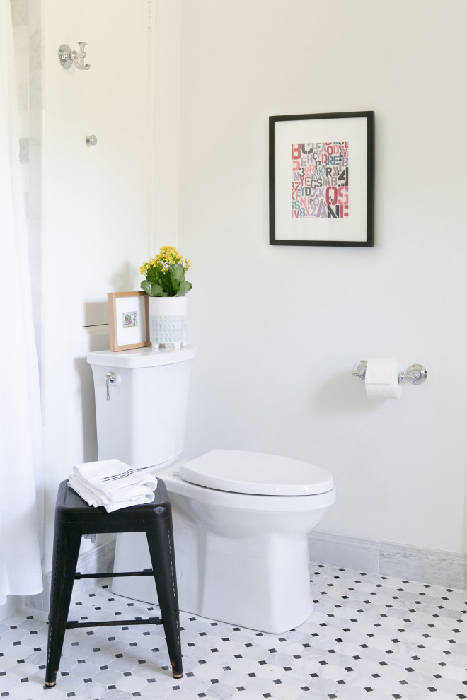 Small transitional kids bathroom in New York with open cabinets, black cabinets, an alcove tub, a shower/bathtub combo, a two-piece toilet, white tile, marble, white walls, marble floors, a trough sink, a shower curtain, white benchtops, a double vanity and a floating vanity.