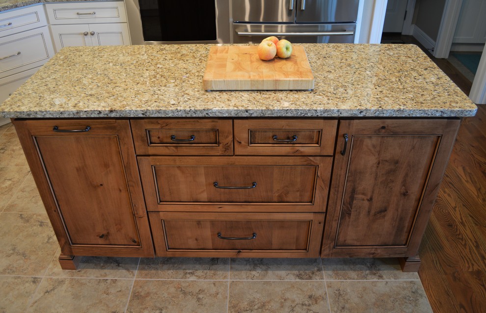 Inspiration for a mid-sized timeless u-shaped ceramic tile and brown floor open concept kitchen remodel with an undermount sink, beaded inset cabinets, white cabinets, granite countertops, gray backsplash, subway tile backsplash, stainless steel appliances, an island and gray countertops
