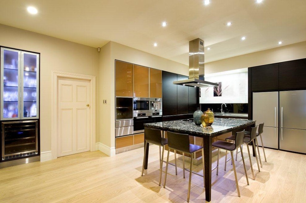 Contemporary kitchen in Auckland with glass-front cabinets and stainless steel appliances.