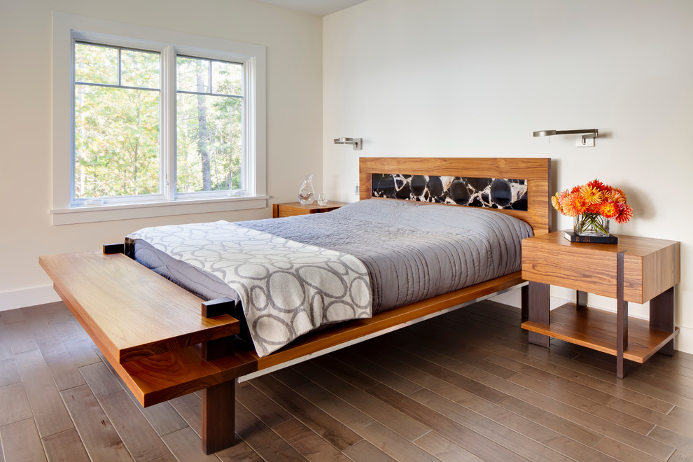 Example of a mid-sized trendy guest dark wood floor bedroom design in Portland Maine with beige walls and no fireplace