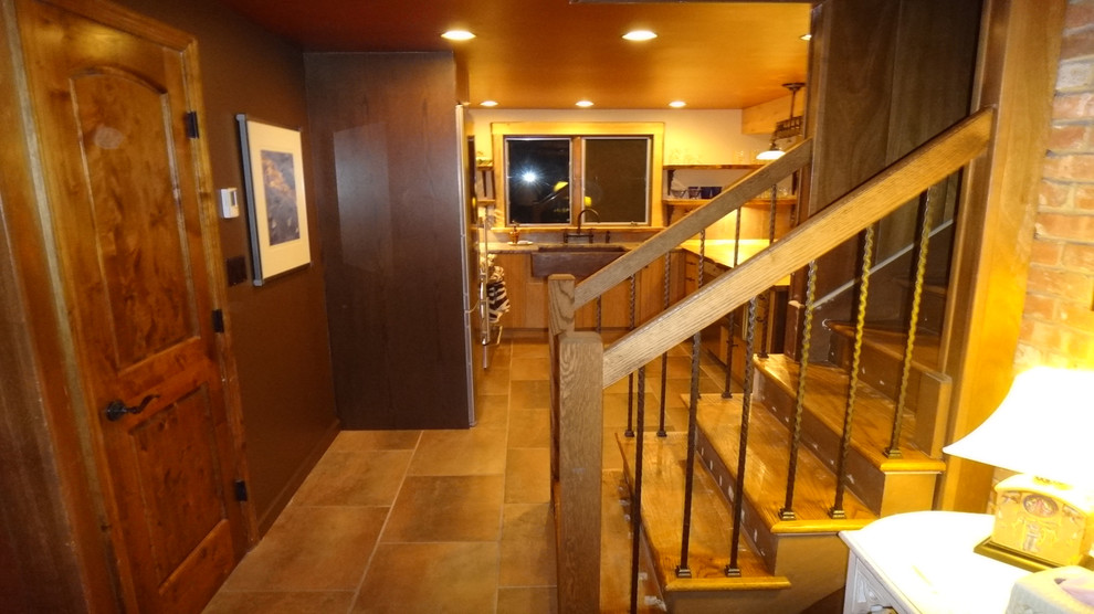 Mid-sized mountain style kitchen photo with medium tone wood cabinets, wood countertops, metallic backsplash and an island