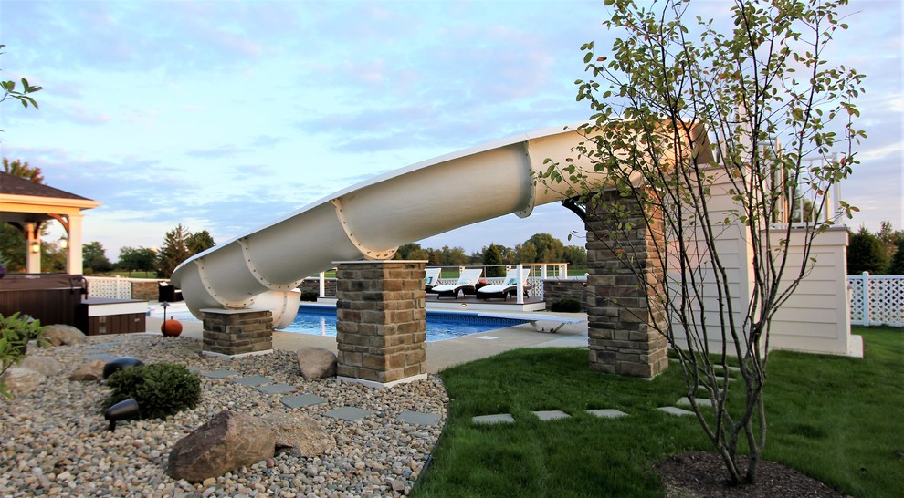 Inspiration for a large transitional backyard rectangular natural water slide remodel with decking