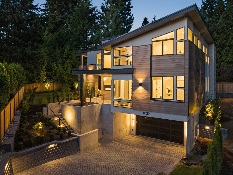 Large contemporary detached house in Seattle with wood cladding and a black roof.