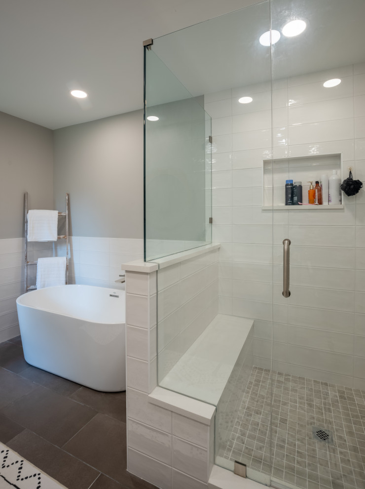 Inspiration for an expansive classic ensuite bathroom in Denver with a freestanding bath, a corner shower, white tiles, ceramic tiles, grey walls, porcelain flooring, engineered stone worktops, grey floors, a hinged door, white worktops, a wall niche, double sinks and a freestanding vanity unit.