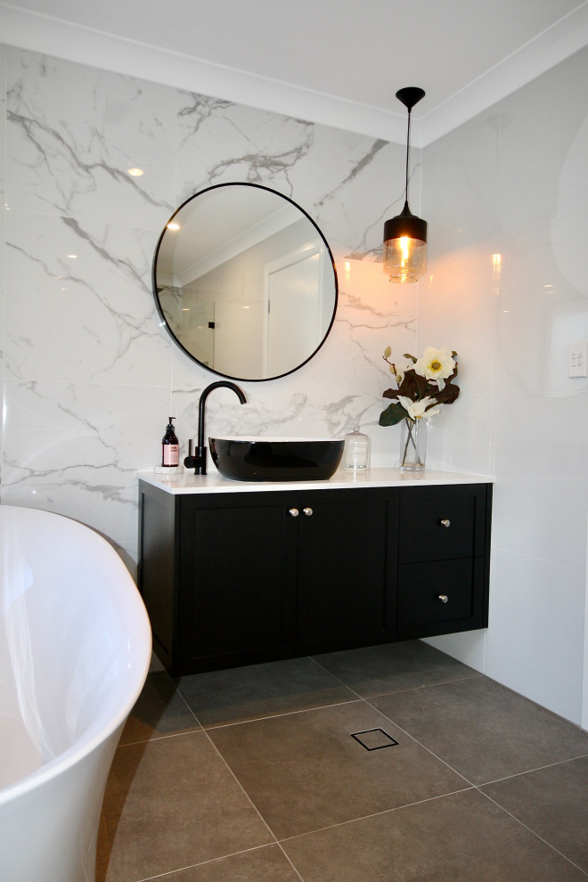 This is an example of a small transitional master bathroom in Sydney with shaker cabinets, black cabinets, white tile, marble, ceramic floors, engineered quartz benchtops, grey floor, white benchtops, a single vanity, a floating vanity and recessed.