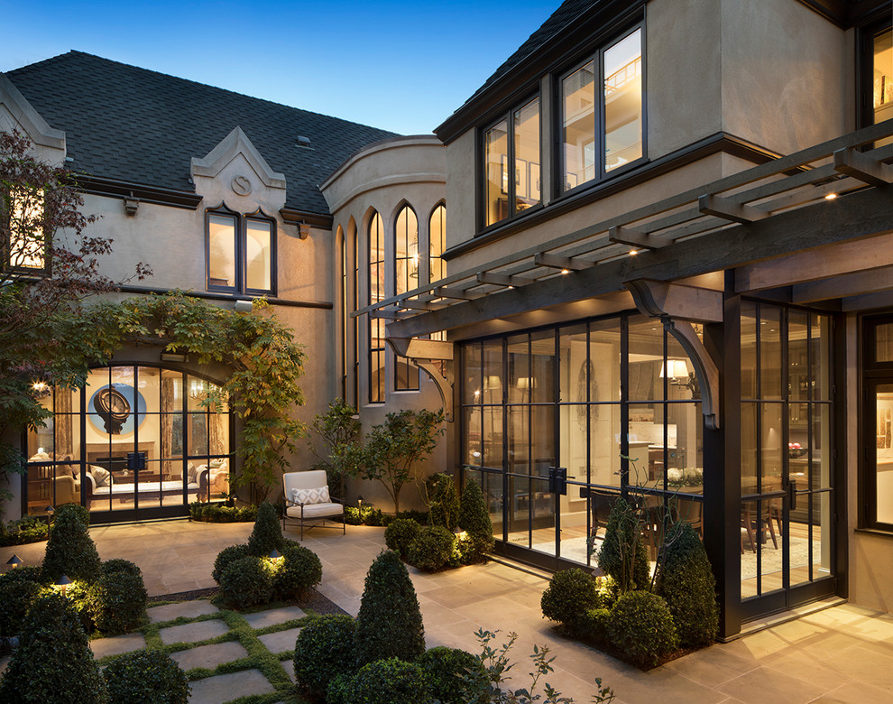 Patio - traditional two-story stucco beige patio idea in San Francisco with a hip roof