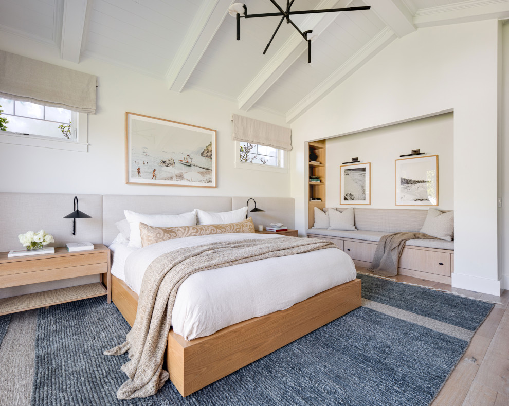 Bedroom - coastal master medium tone wood floor, brown floor, exposed beam and vaulted ceiling bedroom idea in San Diego with white walls