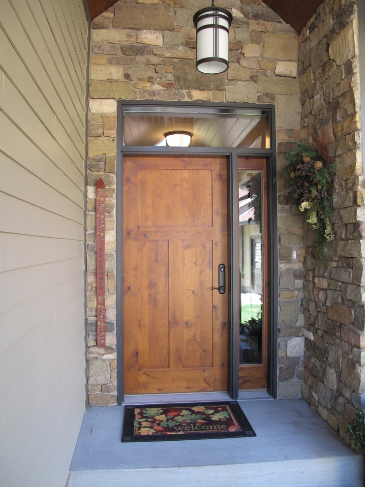Design ideas for a mid-sized transitional front door in Minneapolis with a single front door and a medium wood front door.