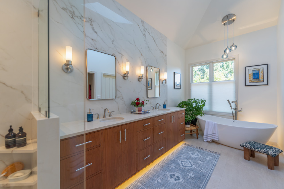 Mid-sized contemporary master bathroom in Portland with flat-panel cabinets, medium wood cabinets, a freestanding tub, white tile, porcelain tile, white walls, porcelain floors, an undermount sink, engineered quartz benchtops, grey floor, white benchtops, a shower seat, a double vanity, a built-in vanity, vaulted, an open shower and an open shower.