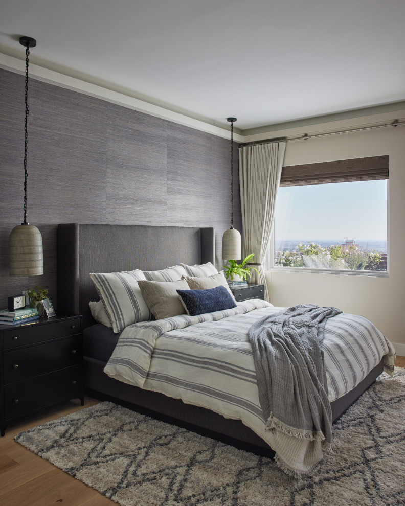 Inspiration for a transitional bedroom in Los Angeles with wallpaper, beige walls, medium hardwood floors and brown floor.
