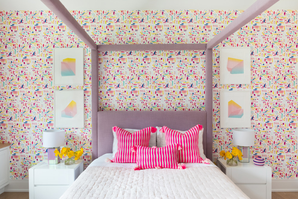 Design ideas for a mid-sized transitional kids' playroom for kids 4-10 years old and girls in New York with multi-coloured walls, light hardwood floors, brown floor, timber and wallpaper.