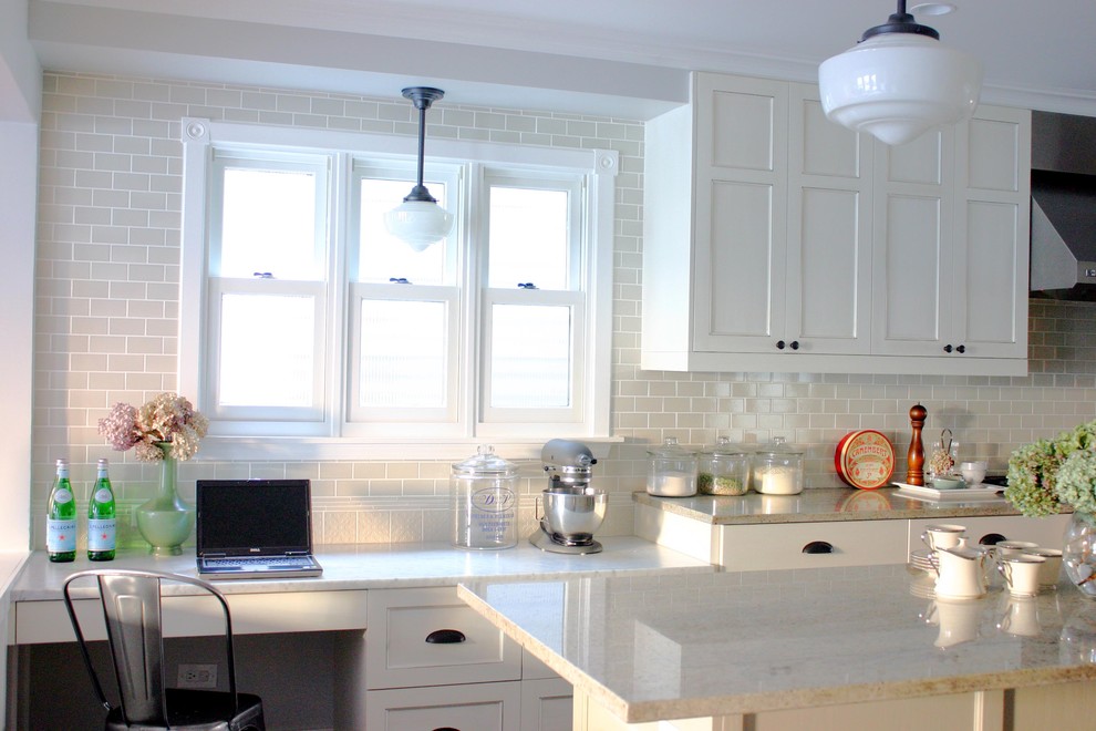 Photo of a traditional kitchen in Chicago with recessed-panel cabinets, white cabinets, granite benchtops, white splashback and subway tile splashback.