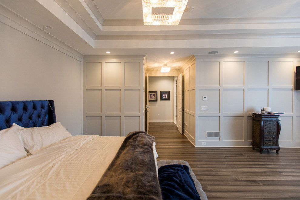 Transitional master bedroom in Detroit with beige walls, dark hardwood floors and brown floor.