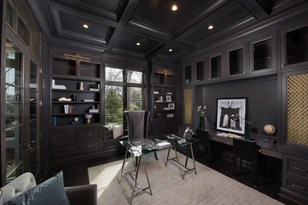Photo of a large transitional home office in Chicago with a library, grey walls, dark hardwood floors, no fireplace, a built-in desk and brown floor.