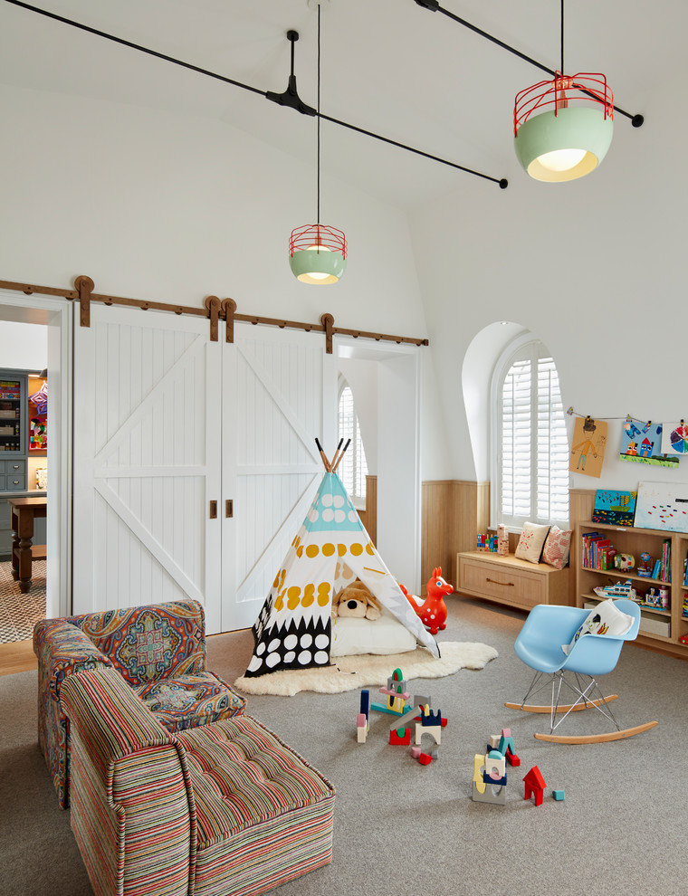 Expansive transitional gender-neutral kids' playroom in Chicago with white walls, carpet and grey floor for kids 4-10 years old.