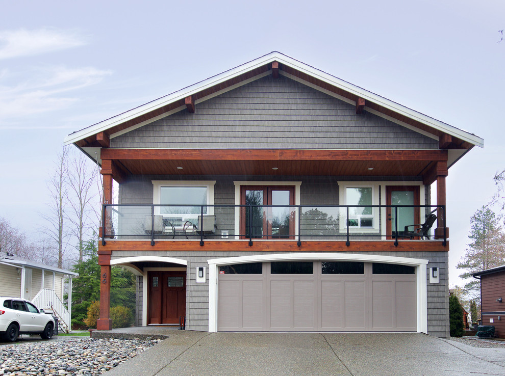 Large traditional two-storey grey exterior in Vancouver with concrete fiberboard siding and a clipped gable roof.