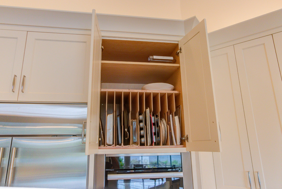 Inspiration for a large transitional single-wall enclosed kitchen remodel with an undermount sink, flat-panel cabinets, white cabinets, quartz countertops, blue backsplash, stone tile backsplash, stainless steel appliances and an island