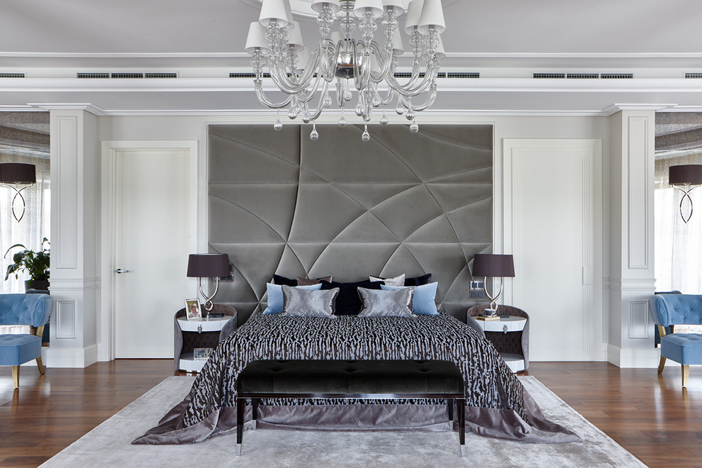 This is an example of a contemporary master bedroom in Moscow with white walls, medium hardwood floors and brown floor.